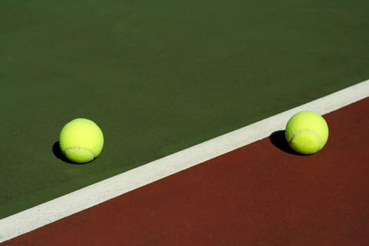 Two tennis balls in a tennis court