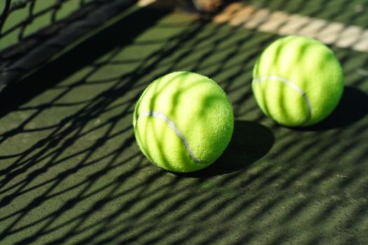 Two tennis balls in a court