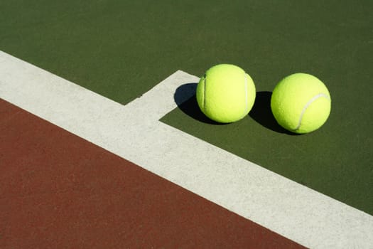 Two tennis balls in a tennis court