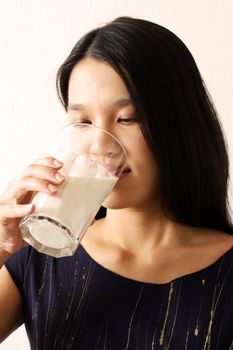 A woman drinking a glass of milk