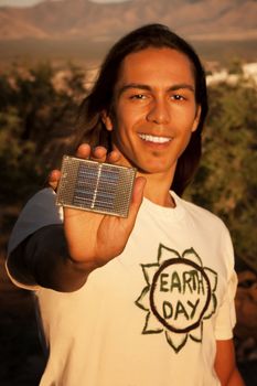 Handsome young mixed race man with small solar panel