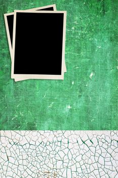 Grungy green background with blank photos. 