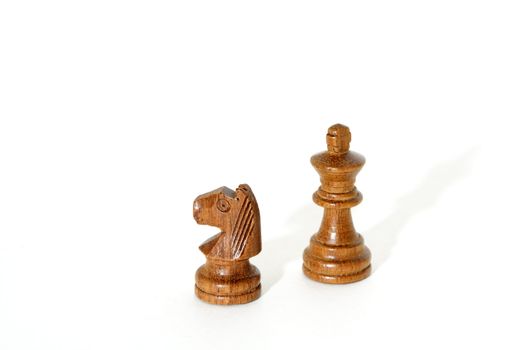 A horse and a king chess pieces on isolated white