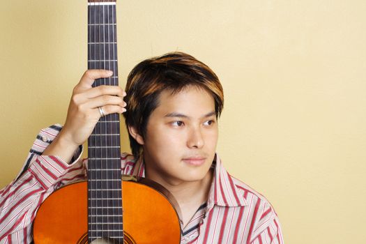 A handsome man holding a guitar