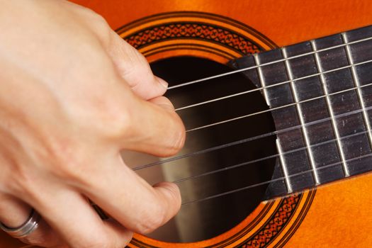 Close up on a man playing guitar