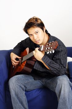 A handsome man playing guitar