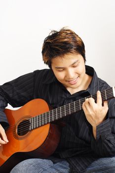 A handsome man playing guitar