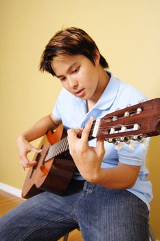 A young man playing guitar