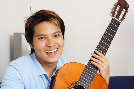 A young man playing guitar