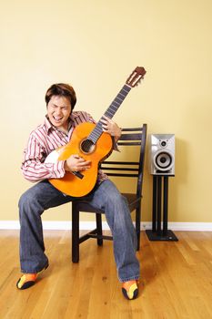 A young man playing guitar