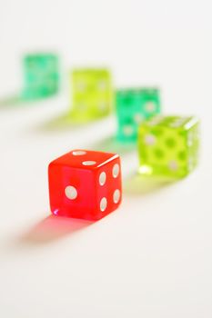 A colorful dice on white (shallow DOF)