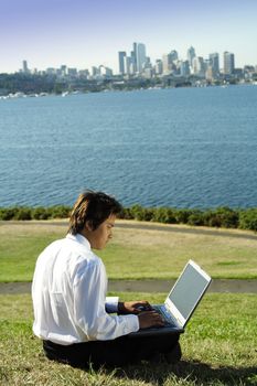 Businessman working on his laptop in a park