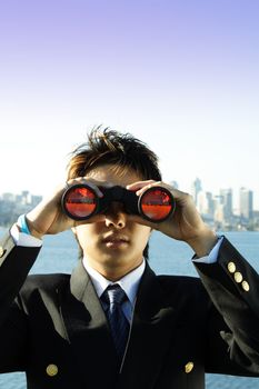 Businessman looking through binoculars, can be used as vision/prospect metaphor