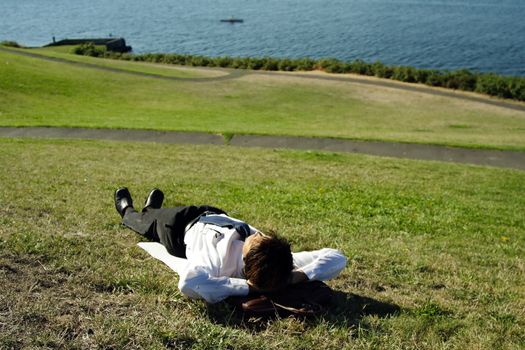 A businessman relaxing at a park