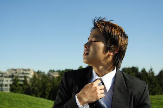 A businessman at an outdoor park