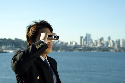 Businessman looking through binoculars, can be used for vision/prospects metaphor