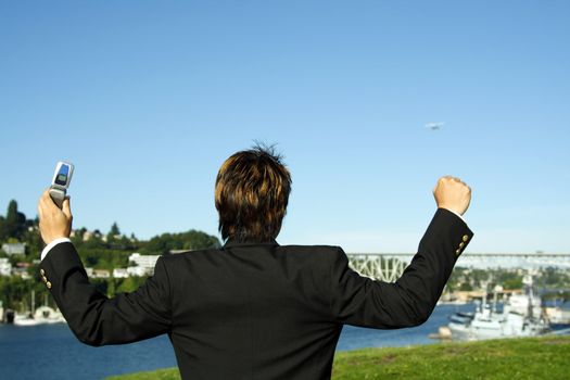 Happy businessman with arms up in the air