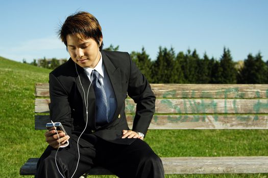 A businessman listening to music