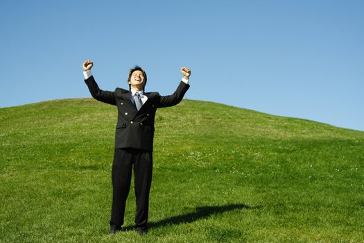 Happy businessman with arms up in the air