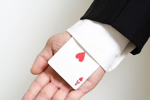 A businessman carrying an ace of hearts