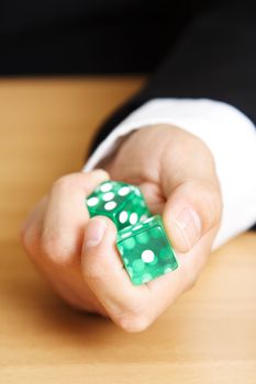 A businessman rolling a dice