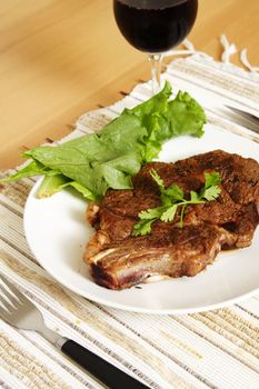 Grilled ribeye steak with a glass of wine