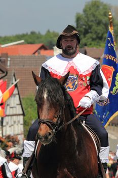 BAD AROLSEN-HELSEN, GERMANY - MAY 24: a rider fron Lanzengarde Helsen in historic clothing taking part in the pageant of a fair featuring shooting matches , Helser Freischiessen 2010 May 24, 2010 in Bad Arolsen-Helsen, Germany