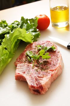 Seasoned ribeye steak ready for grill