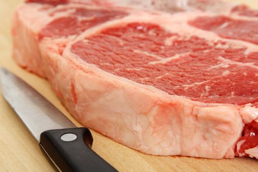 Close up of a ribeye steak and a knife