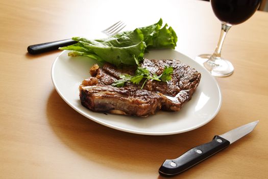 Grilled steak dinner with a glass of wine