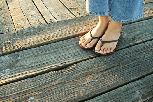 A woman's feet on a boardwalk