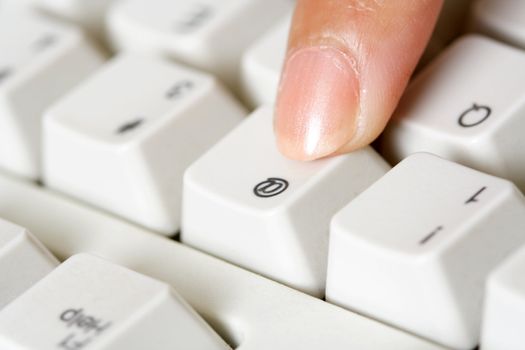 A businesswoman pressing a key on a keyboard