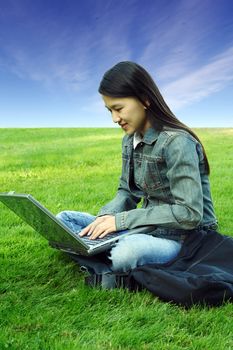 A girl with laptop working outdoor