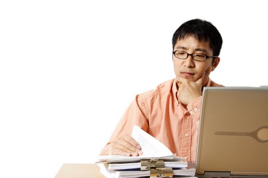 Busy businessman with laptop and a stack of paper