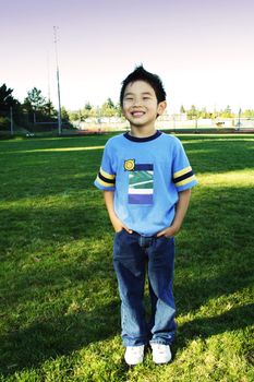 A boy posing at a park