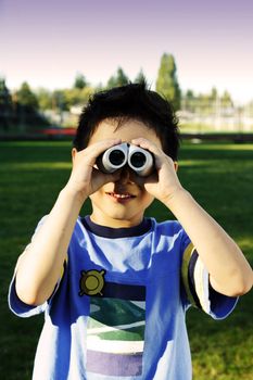 A boy looking through a binocular