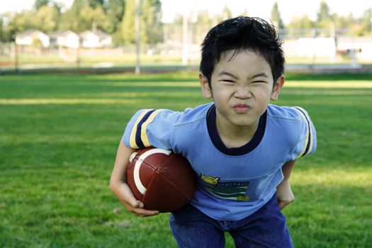 A boy playing football outdoor