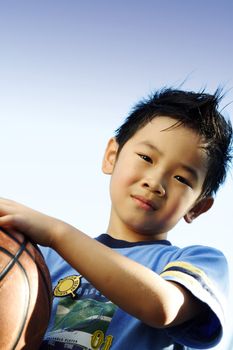 A boy playing basketball outside