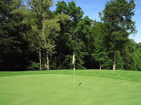 A photograph of a golf course in the afternoon.