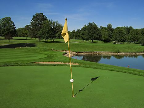 A photograph of a golf course in the afternoon.