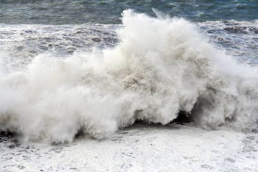 Giant wave breaks on the lighthouse during a storm in Mediterranean sea