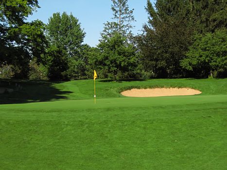 A photograph of a golf course in the afternoon.