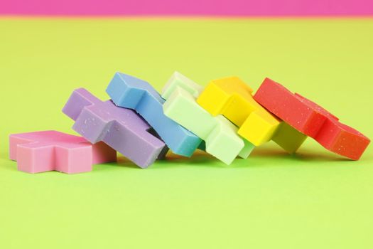Colorful eraser puzzle pieces in a row laying down.