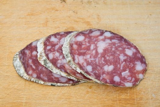 salami sliced on cutting board