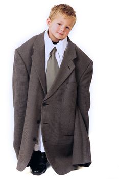 Blond young Boy in oversized business clothes standing