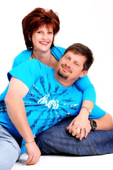 married couple with husband leaning on wife's lap and smiling