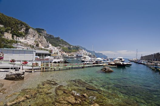 Amalfi Coast, transparent water in the harbor with boat. Naples - Best of Italy