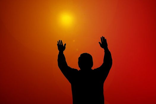 Sunset beam shining on man with hands up