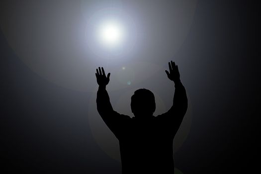 Sun beam shining on man with hands up