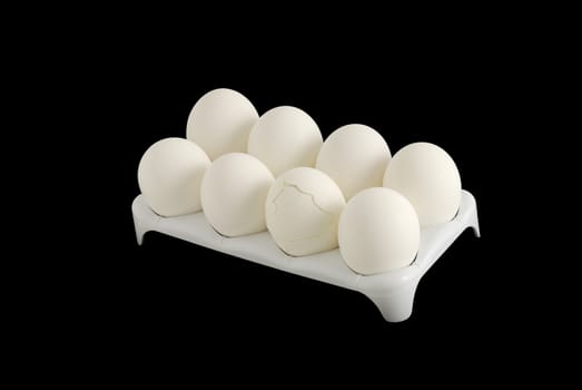 Eight white eggs with one cracked in carton isolated on black background